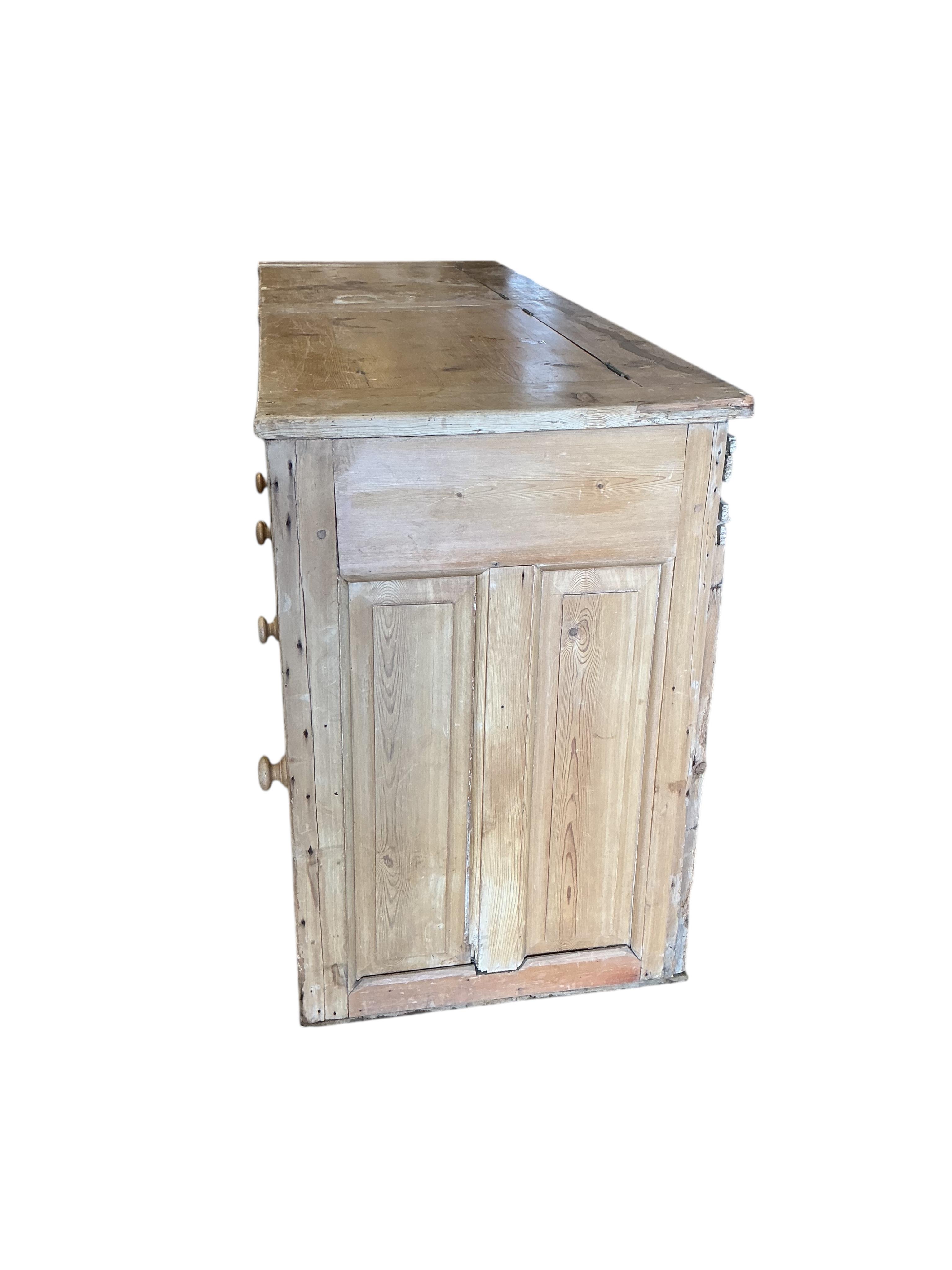 A Victorian pine low dresser with twin hinged compartment top, width 150cm, depth 53cm, height 80cm